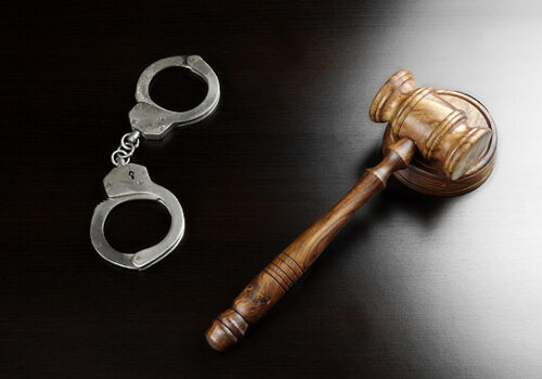 gavel and handcuffs on a table