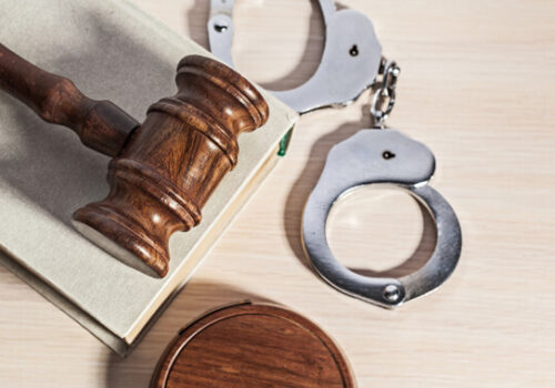 gavel on table with handcuffs