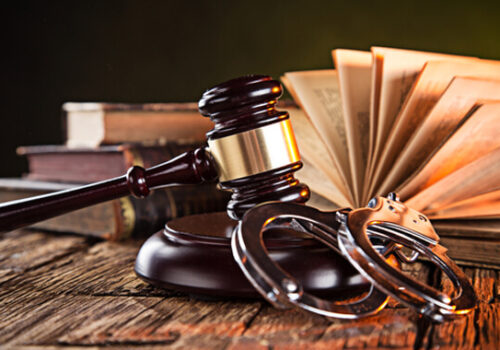 gavel and handcuffs on desk
