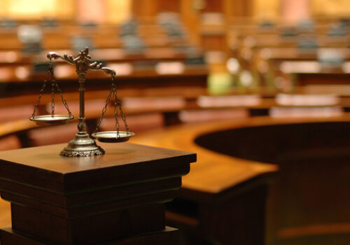 old law scales with blurred assembly hall in the background