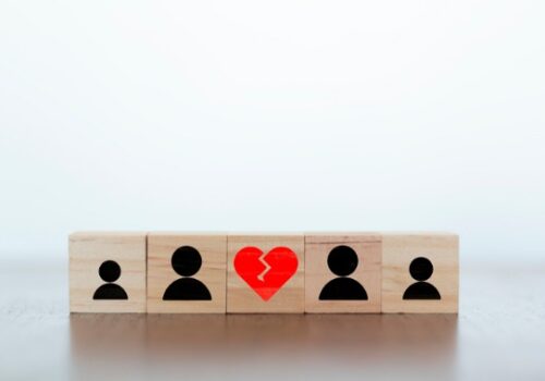 Blocks representing a family with a broken heart in between two sides