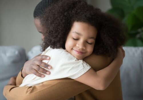 A daughter hugging her father