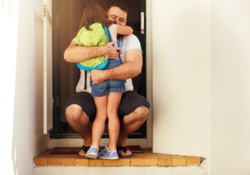 A happy girl hugging her dad during a Visitation in Peoria IL