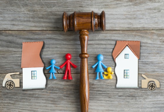 A gavel separating a picture and figures of a family, representing a East Peoria IL Divorce Attorney