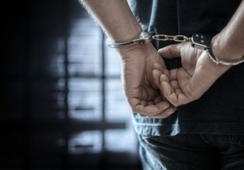 A person in handcuffs needs to contact a Criminal Defense Attorney in Central Illinois