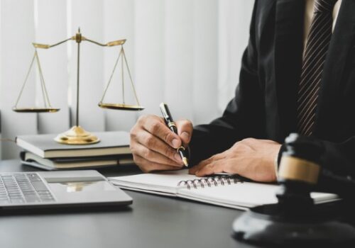A lawyer writes in a notebook, representing Juvenile Law in East Peoria IL