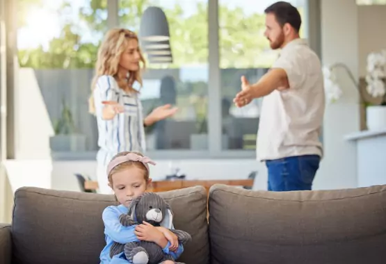 A couple fights while their daughter hugs a stuffed animal. Borsberry Law is a Child Custody Attorney in East Peoria IL