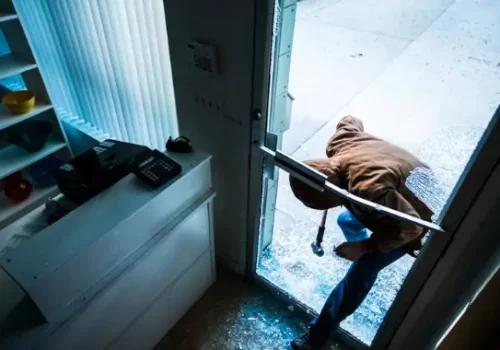 Individual sneaking in broken door with a hammer and committing a theft crime in Peoria IL.