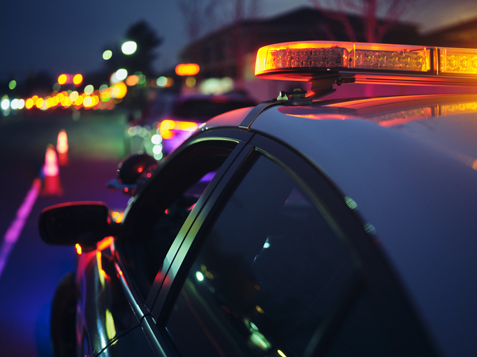 A police car stopping a vehicle at night making it necessary to call a DUI Lawyer Peoria IL trusts